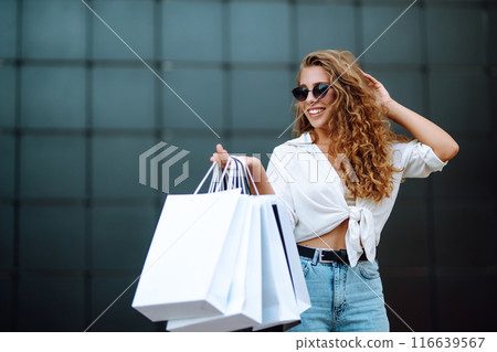 Woman in shopping. Woman with shopping bags walking around city after shopping. Lifestyle concept. 116639567