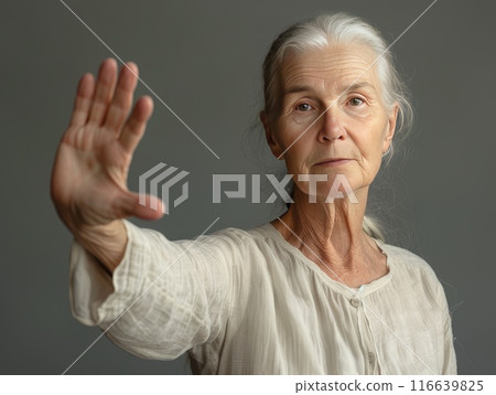 An elderly woman makes a stop gesture with her palm, against domestic violence. AI-generated content 116639825