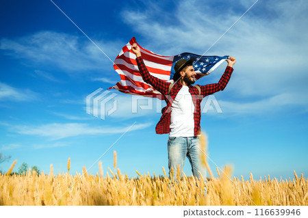 4th of July. American Flag.Patriotic holiday. Traveler with the flag of America. Beautiful sunset light. American style. 116639946
