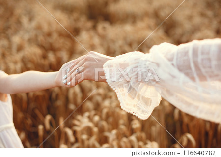 Family in a summer field. Sensual photo. Cute little girl. Woman in a white dress. Family in a summer field. Sensual photo. Cute little girl. Woman in a white dress. 116640782