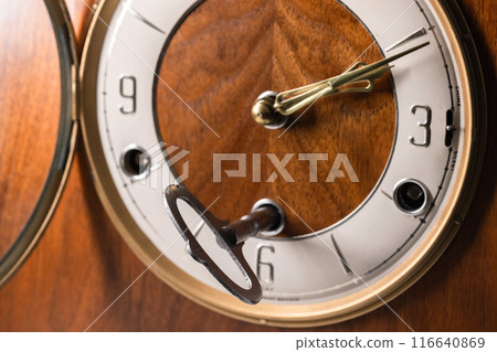 Winding key of vintage chiming mantel clock 116640869