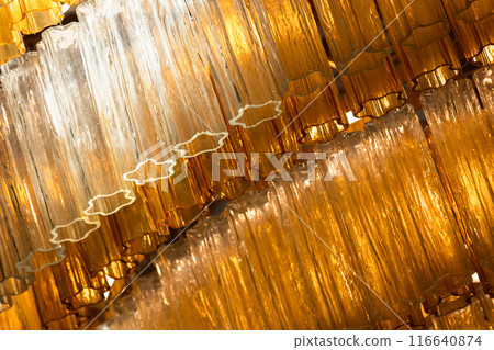Yellow glass details of a luxury vintage chandelier. Close-up photo 116640874