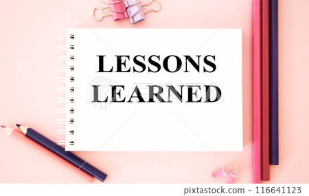 LESSONS LEARNED text on pink background and with pencils.The image shows a slogan Lessons Learnd written on a pink notebook. Bright picture. Concept Image. Can be used as template, signboard, banner LESSONS LEARNED text on pink background and with pencils.The image shows a slogan Lessons Learnd written on a pink notebook. Bright picture. Concept Image. Can be used as template, signboard, banner 116641123