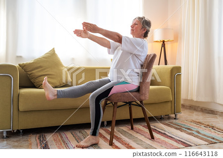 Senior caucasian woman doing yoga at home on chair 116643118