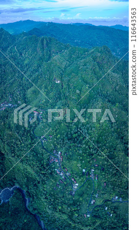 Aerial view The waterfall stream flows into the mountain gorge in a long path. Aerial view The waterfall stream flows into the mountain gorge in a long path. 116643563
