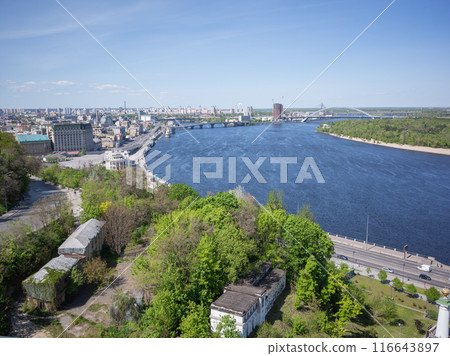 [Ukraine] The Dnieper River and cityscape surrounded by green forests as seen from a hill in the capital, Kyiv 116643897