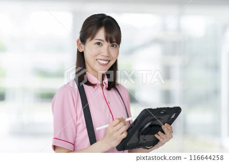 Image of facility staff holding a tablet Image of facility staff holding a tablet 116644258