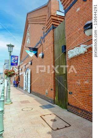 Landscape with a red brick warehouse and tourists (vertical) 116644291