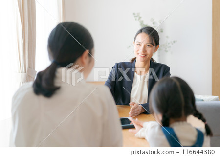 穿著西裝的女人在家裡與父母和孩子交談 116644380