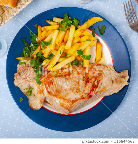 Fried Iberian pig served with potatoes Fried Iberian pig served with potatoes 116644562