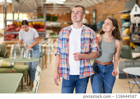 Spouses look for something in furniture store, searching for perfect item to complete patio 116644587