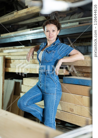 Portrait of positive female lumber warehouse worker Portrait of positive female lumber warehouse worker 116644616