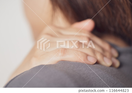 A woman suffering from stiff shoulders A woman suffering from stiff shoulders 116644823