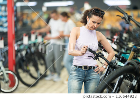 Adult woman choosing bike in store 116644928
