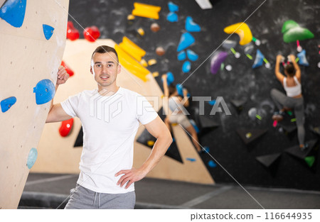 Young man posing near climbing wall 116644935
