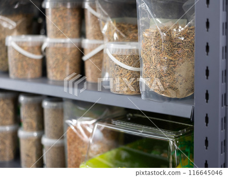Pet shop display shelf with packages of pellets for feeding turtles Pet shop display shelf with packages of pellets for feeding turtles 116645046
