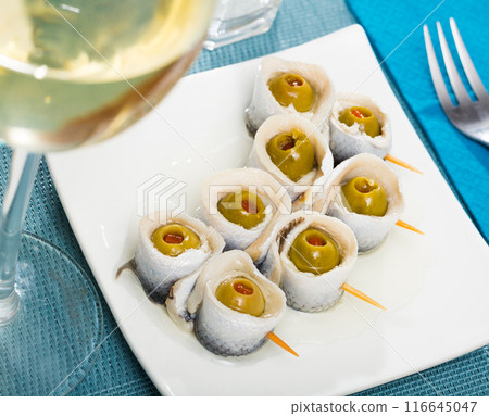 Herring rolls with stuffed olives Herring rolls with stuffed olives 116645047