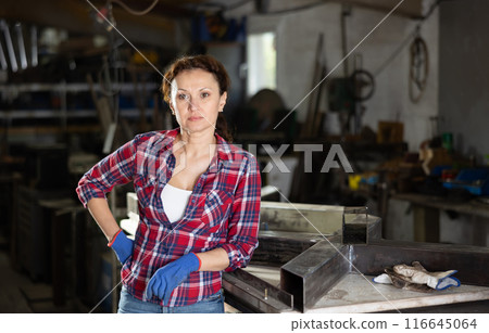 Adult woman posing in oak workshop 116645064