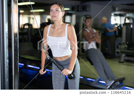 Young woman training with straps in gym Young woman training with straps in gym 116645216