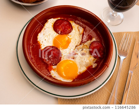 Spanish tapas with chorizo sausage and tomato paste closeup 116645286