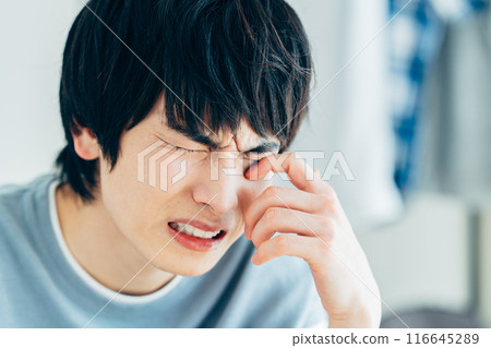 一名因花粉熱而眼睛發癢的年輕人 116645289