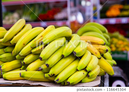Bunch of bananas lies on counter in shop Bunch of bananas lies on counter in shop 116645304