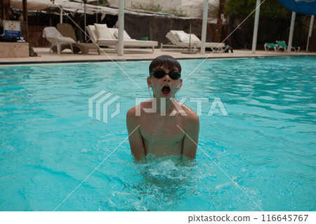 Boy with glasses swims in the pool Boy with glasses swims in the pool 116645767