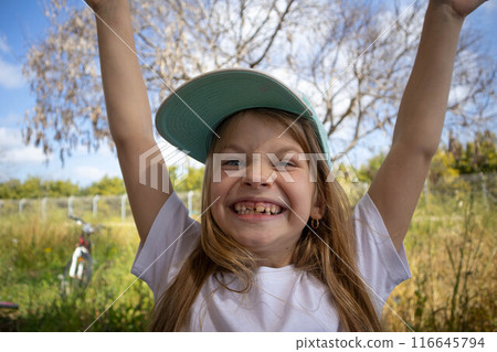 The little girl smiles. Permanent teeth appeared. 116645794