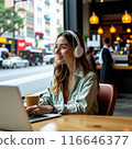 Smiling young woman talking through headphones 116646377