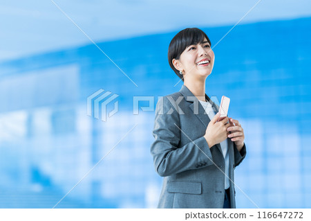 A business person operating a smartphone. A business person operating a smartphone. 116647272