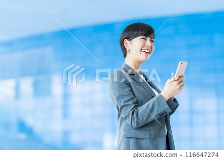 A business person operating a smartphone. 116647274