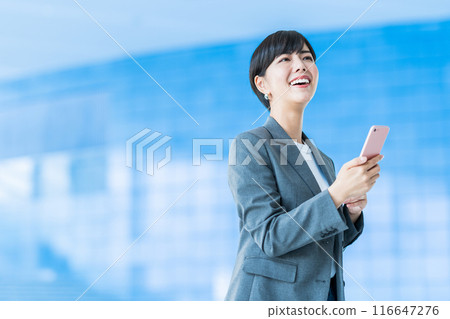 A business person operating a smartphone. 116647276