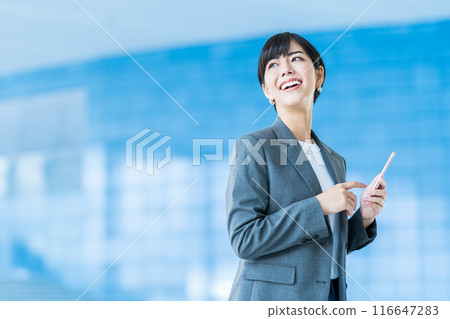 A business person operating a smartphone. 116647283
