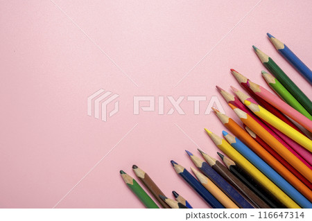 A row of colored pencils on a pink background 116647314