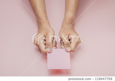 A human hand holding a note A human hand holding a note 116647708