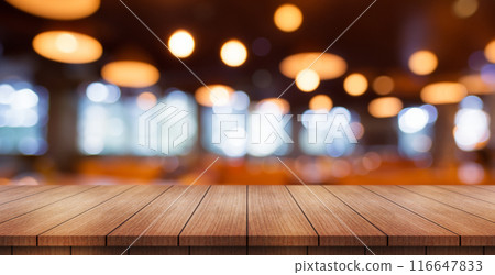 Empty wooden table top with lights bokeh on blur restaurant background. 116647833