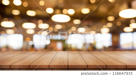 Empty wooden table top with lights bokeh on blur restaurant background. Empty wooden table top with lights bokeh on blur restaurant background. 116647835
