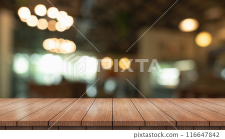 Empty wooden table top with lights bokeh on blur restaurant background. 116647842