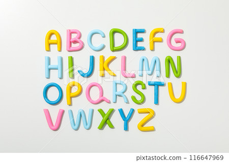 Alphabet made of colored plasticine on a light background. 116647969