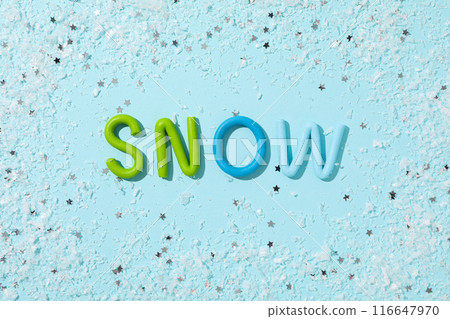 The word "snow" is made of colored plasticine on a blue background. 116647970
