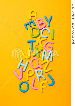 Alphabet made of colored plasticine on a light background. 116647974