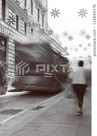 Blur black and white photograph of an urban street in the big city of Genoa Italy and inhabitants. City life. 116648376