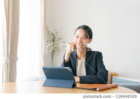 Woman doing work at home Woman doing work at home 116648589