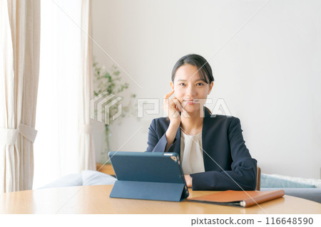 Woman doing work at home Woman doing work at home 116648590