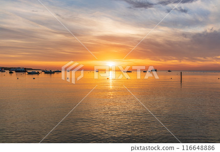 Beautiful red and orange sunrise over the sea. Beautiful red and orange sunrise over the sea. 116648886