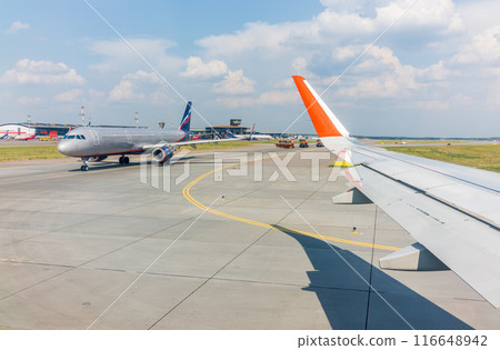 View from the airplane window during takeoff at Sheremetyevo airport at summer View from the airplane window during takeoff at Sheremetyevo airport at summer 116648942