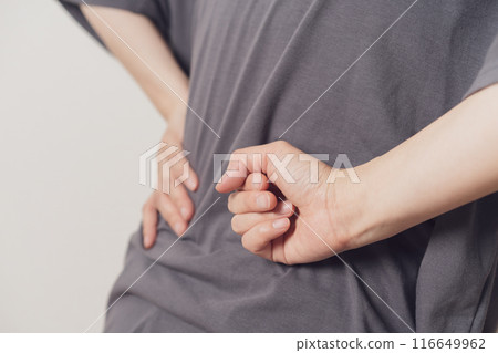 A woman with painful hands on her hips 116649962