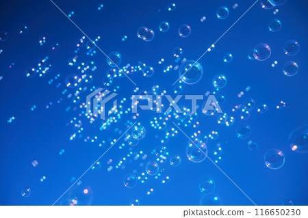 Colorful bubbles floating against a vibrant blue sky Colorful bubbles floating against a vibrant blue sky 116650230