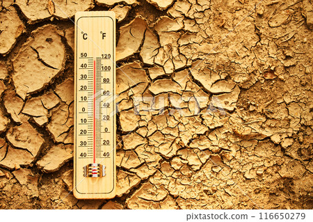 Climate change concept. Thermometer on arid, cracked soil representing extreme heat and drought conditions. Climate change concept. Thermometer on arid, cracked soil representing extreme heat and drought conditions. 116650279
