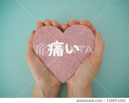 Heart in both hands with the word "ouch" written on it 116651082